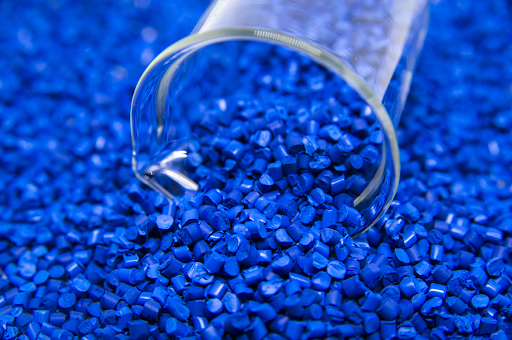 tube in mound of blue plastic pellets